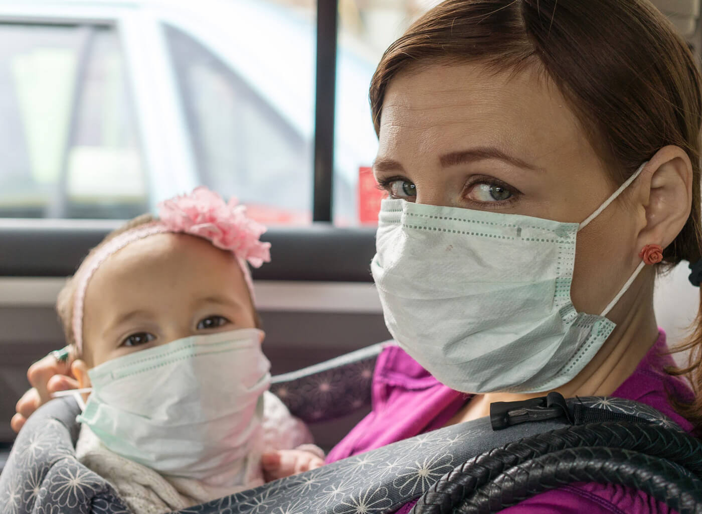 woman and baby wearing masks